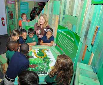 Children playing a game included in the new energy-conservation exhibits at the CRRA Trash Museum.