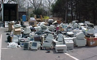 pile of home electronics at a collection site